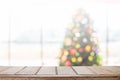 Wood table top with blur christmas tree bokeh background Royalty Free Stock Photo