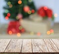 Wood table top on blur colorful Christmas tree and gold bokeh background Royalty Free Stock Photo