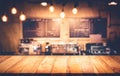 Wood table top with blur counter coffee shop, cafe background. Royalty Free Stock Photo