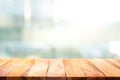 Wood table top on blur glass window wall building background. Royalty Free Stock Photo