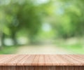 Wood table top on blur green background of trees in the park. Royalty Free Stock Photo