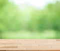 Wood table top on blur green background of trees in the park. Royalty Free Stock Photo