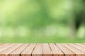Wood table top on blur green background of trees in the park. Royalty Free Stock Photo