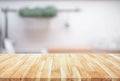 Wood table top on blur kitchen counter roombackground