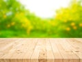 Wood table top with blur of orange garden in the morning.For montage product display or design key visual Royalty Free Stock Photo