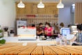 Wood table top with blur of people in coffee shop background. For montage product display or design key visual layout Royalty Free Stock Photo