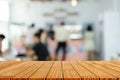 Wood table top with blur of people in coffee shop background. For montage product display or design key visual layout Royalty Free Stock Photo