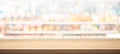 Wood table top on blur of supermarket product shelf background Royalty Free Stock Photo