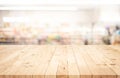 Wood table top on blur of supermarket product shelf background Royalty Free Stock Photo