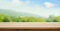 Wood table top on blur tree and mountain background