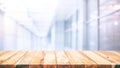 Wood table top on blur white glass wall background form office