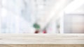 Wood table top on blur white glass wall background form office