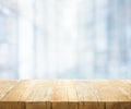 Wood table top on blur white glass wall background Royalty Free Stock Photo