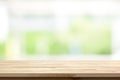 Wood table top on blur white green kitchen window background