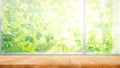 Wood table top on blur of window with garden flower background in morning Royalty Free Stock Photo