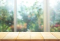 Wood table top on blur of window with garden flower background Royalty Free Stock Photo
