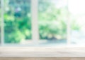 Wood table top on blur of window with garden flower background Royalty Free Stock Photo