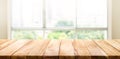 Wood table top on blur of window glass and abstract green garden Royalty Free Stock Photo