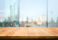 Wood table top on blur window glass,wall background with city view.For montage product display or design key visual Royalty Free Stock Photo