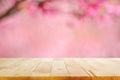 Wood table top on blurred background of pink cherry blossom flowers Royalty Free Stock Photo