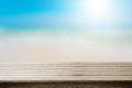 Wood table top on blurred beach background, summer concept. Royalty Free Stock Photo