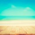 Wood table top on blurred beach background, vintage tone Royalty Free Stock Photo