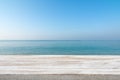 Wood table top on blurred blue sea and white sand beach background