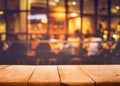 Wood table top on blurred of cafe restaurant with light gold Royalty Free Stock Photo