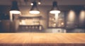 Wood table top on blurred of counter cafe shop with light bulb background Royalty Free Stock Photo