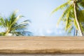 Wood table top with blurred sea and coconut trees background Royalty Free Stock Photo