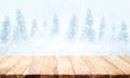Wood table top on blurred snowfall in winter season background. Royalty Free Stock Photo