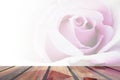 Wood table top on brown, purple rose flower abstract blur background.