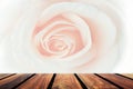 Wood table top on brown, white rose flower abstract blur background.