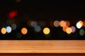 Wood table top on colorful bokeh background at night