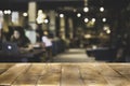 Wood Table top Counter with blurred of coffee shop or modern library. Royalty Free Stock Photo