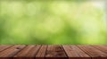 Wood table top on Defocus Bokeh Green Nature background,Abstract blurry light with Empty brown wooden perspective counter,Backdrop Royalty Free Stock Photo