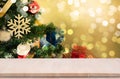 Wood table top on gold bokeh christmas tree background. Royalty Free Stock Photo