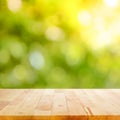 Wood table top on green bokeh abstract background Royalty Free Stock Photo