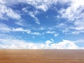 Wood table top over blue sky background with white clouds Royalty Free Stock Photo