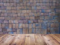 Wood table top over square clay tiles and brick wall pattern Royalty Free Stock Photo