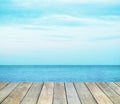 Wood table top over summer sea and blue sky with white clouds background Royalty Free Stock Photo