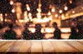 Wood table top with snowfall and people in night winter background Royalty Free Stock Photo