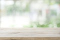 Wood table top on white abstract window glass background.