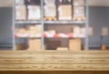 Wood table in warehouse storage blur background.