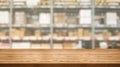 Wood table in warehouse storage blur background.