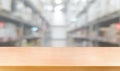 Wood table in warehouse storage blur background.