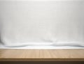 Wood table with white cotton fabric background Royalty Free Stock Photo