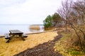 Wood table and wooden bench in sand beach in french lake of Sanguinet France