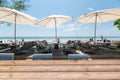 Wood tabletop on dining table with umbrella on the beach Royalty Free Stock Photo