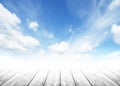 Wood tabletop foreground with sunshine clouds sky during morning background. Blue,white pastel heaven,soft focus lens flare sunlig